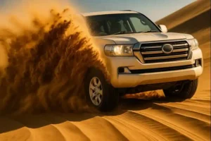 land cruiser dune bashing close-up with sand splash in dubai desert