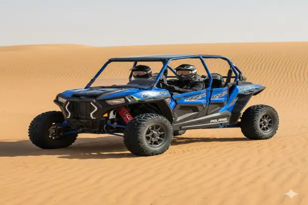 Blue Polaris RZR 2 seater dune buggy parked on golden desert sand under clear daylight