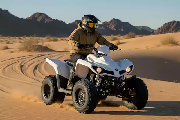 Sharmax quad bike riding in desert dunes with rider wearing helmet, real off-road adventure